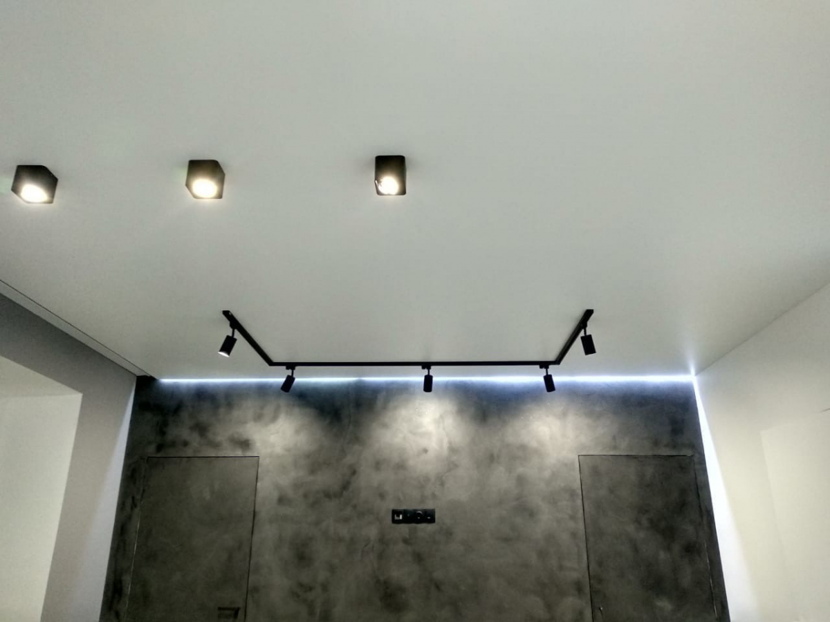 Черные точечные светильники на белом потолке